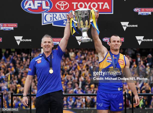 Eagles head coach Adam Simpson and Shannon Hurn of the Eagles hold up the premiership cup after their win during the 2018 AFL Grand Final match...