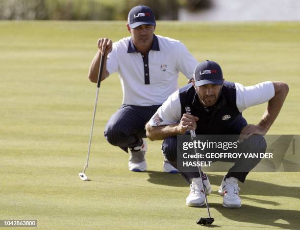 Golfer Dustin Johnson and US golfer Brooks Koepka line up a putt during their his foursomes match on the second day of the 42nd Ryder Cup at Le Golf...