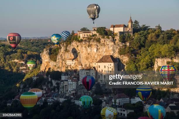 Hot air balloons take off above the tourist site of Rocamadour, southwestern France, on September 29 during the "33rd Montgolfiades", which brought...