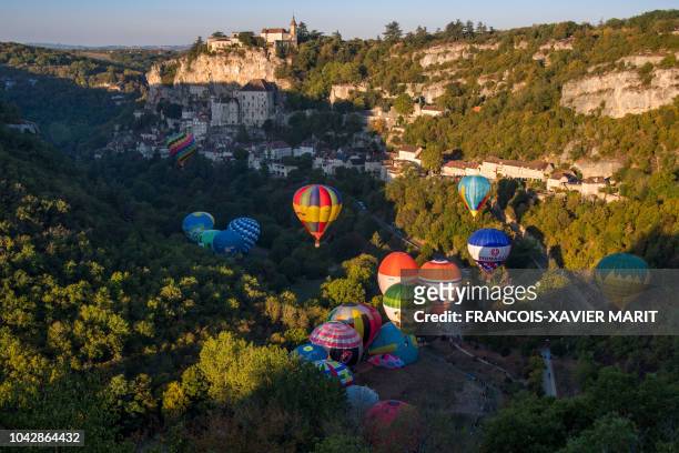 Hot air balloons take off above the tourist site of Rocamadour, southwestern France, on September 29 during the "33rd Montgolfiades", which brought...