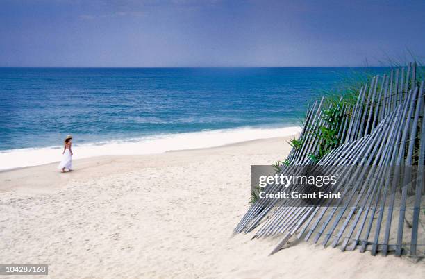 young woman  walking on beach - the hamptons stock pictures, royalty-free photos & images