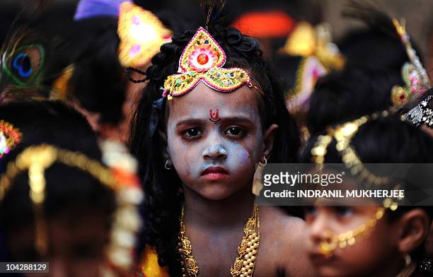 Indian school students dressed as Hindu god Lord Krishna and his childhood friend and lover Radha await their turn during a fancy dress competition...