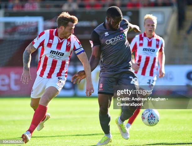 Lincoln City's John Akinde shields the ball from Cheltenham Town's Johnny Mullins during the Sky Bet League Two match between Cheltenham Town and...