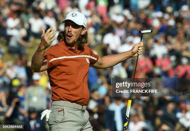 Europe's English golfer Tommy Fleetwood reacts during his foursomes match on the second day of the 42nd Ryder Cup at Le Golf National Course at...