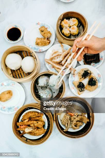 enjoying a variety of chinese traditional dim sum in chinese restaurant - flat lay food stock pictures, royalty-free photos & images