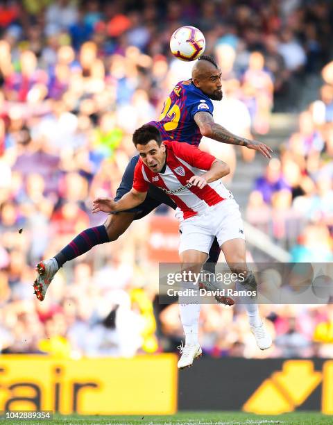 Benat Etxebarria of Athletic Club competes for the ball with Arturo Vidal of FC Barcelona during the La Liga match between FC Barcelona and Athletic...