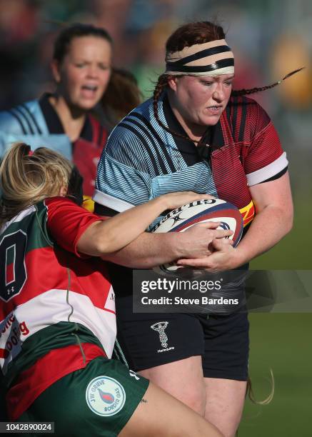 Chloe Edwards of Harlequins Ladies is tackled by Beth Stott of Firewood Waterloo Ladies during the Tyrrells Premier 15s match between Harlequins...