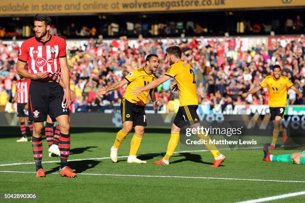 Jonny Otto of Wolverhampton Wanderers celebrates scoring his sides second goal with Matt Doherty as Wesley Hoedt of Southampton stands dejected...