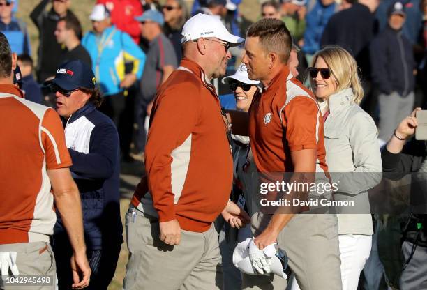 Thomas Bjorn the European Team captain bumps chests with Henrik Stenson after he and Justin Rose had won their top match by 2&1 against Brooks Koepka...