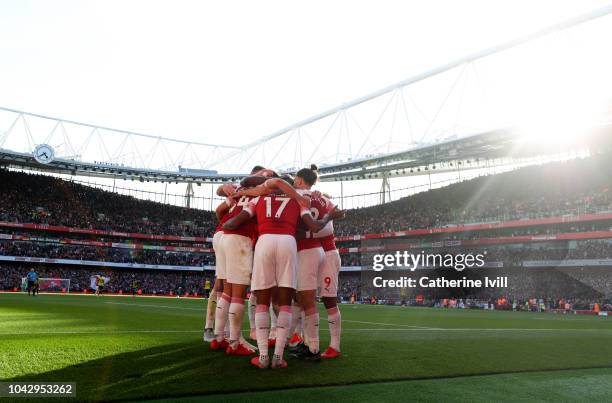 Arsenal celebrate after Craig Cathcart of Watford scores an own goal during the Premier League match between Arsenal FC and Watford FC at Emirates...