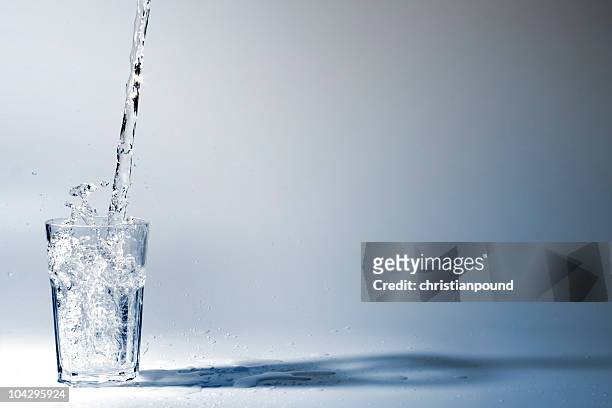 drinking water - bekerglas stockfoto's en -beelden