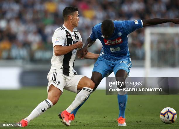 Napoli's Senegalese defender Kalidou Koulibaly obstructs Juventus' Portuguese forward Cristiano Ronaldo during the Italian Serie A football match...