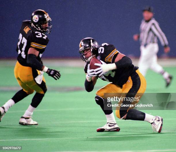 Linebacker Chad Brown of the Pittsburgh Steelers intercepts a pass by quarterback Vinny Testaverde of the Cleveland Browns as safety Carnell Lake...