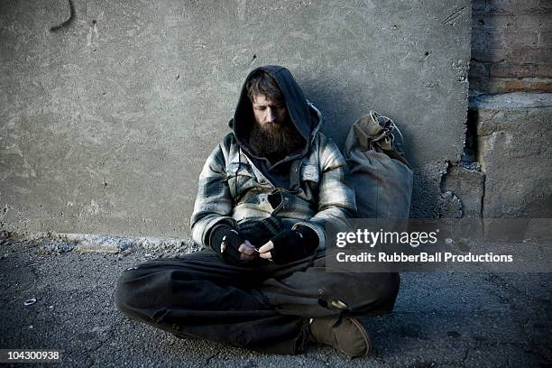 usa, utah, salt lake city, homeless man with sack sitting on sidewalk - homeless stock pictures, royalty-free photos & images