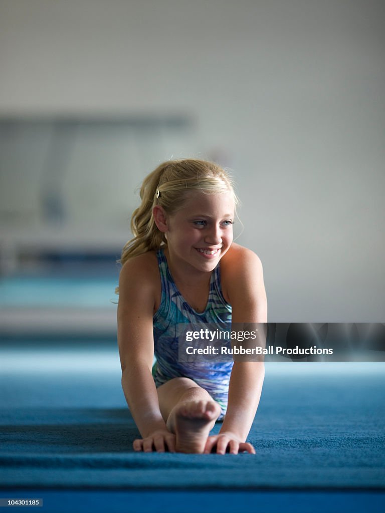 USA, Utah, Orem, girl gymnast (10-11) performing splits
