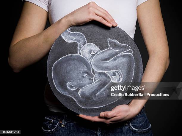 woman with a drawing of a baby - fetus stock-fotos und bilder