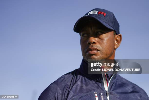 Golfer Tiger Woods looks on during his foursomes match on the second day of the 42nd Ryder Cup at Le Golf National Course at...