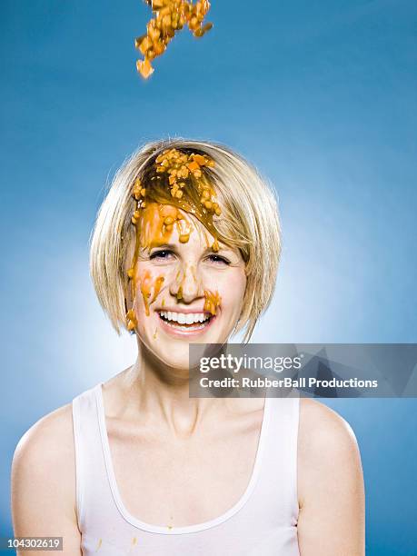woman getting food dumped on her head - food fight stock pictures, royalty-free photos & images