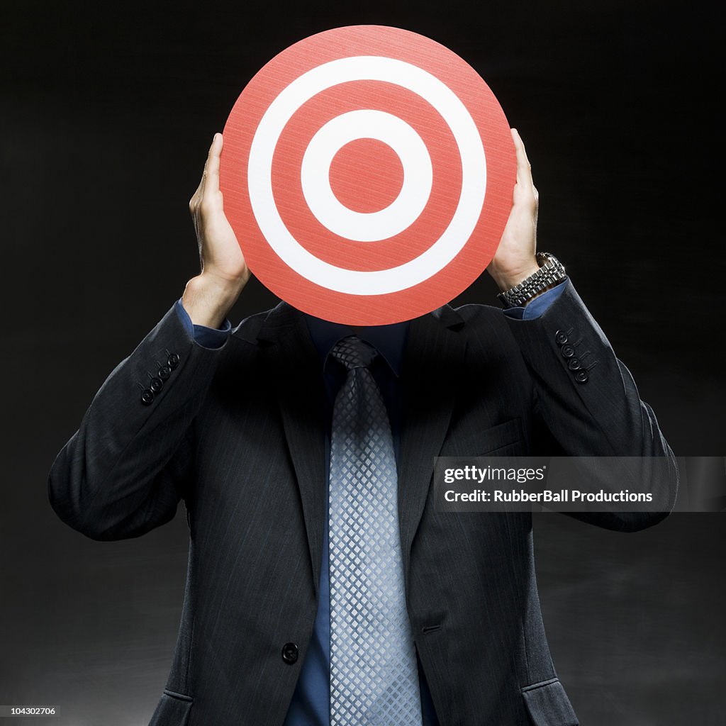 Businessman with a target in front of his face