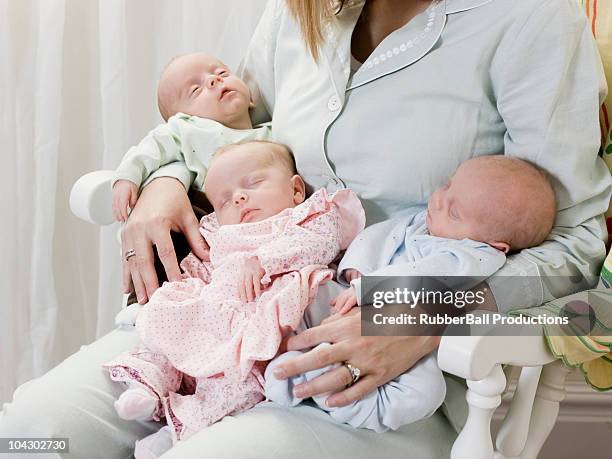 mother with newborn triplets - triplet girls stock pictures, royalty-free photos & images