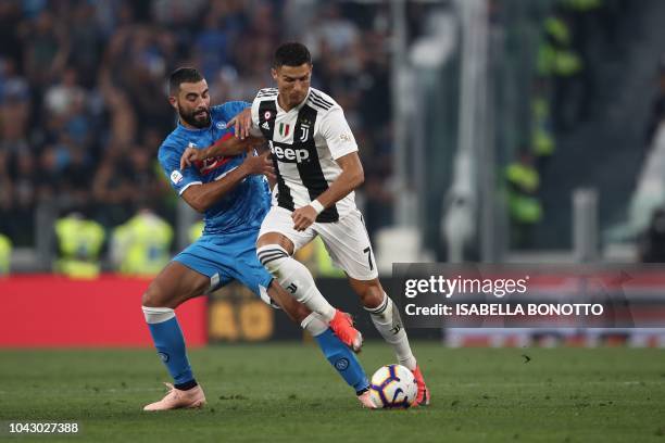 Juventus' Portuguese forward Cristiano Ronaldo holds off Napoli's Spanish defender Raul Albiol during the Italian Serie A football match Juventus vs...
