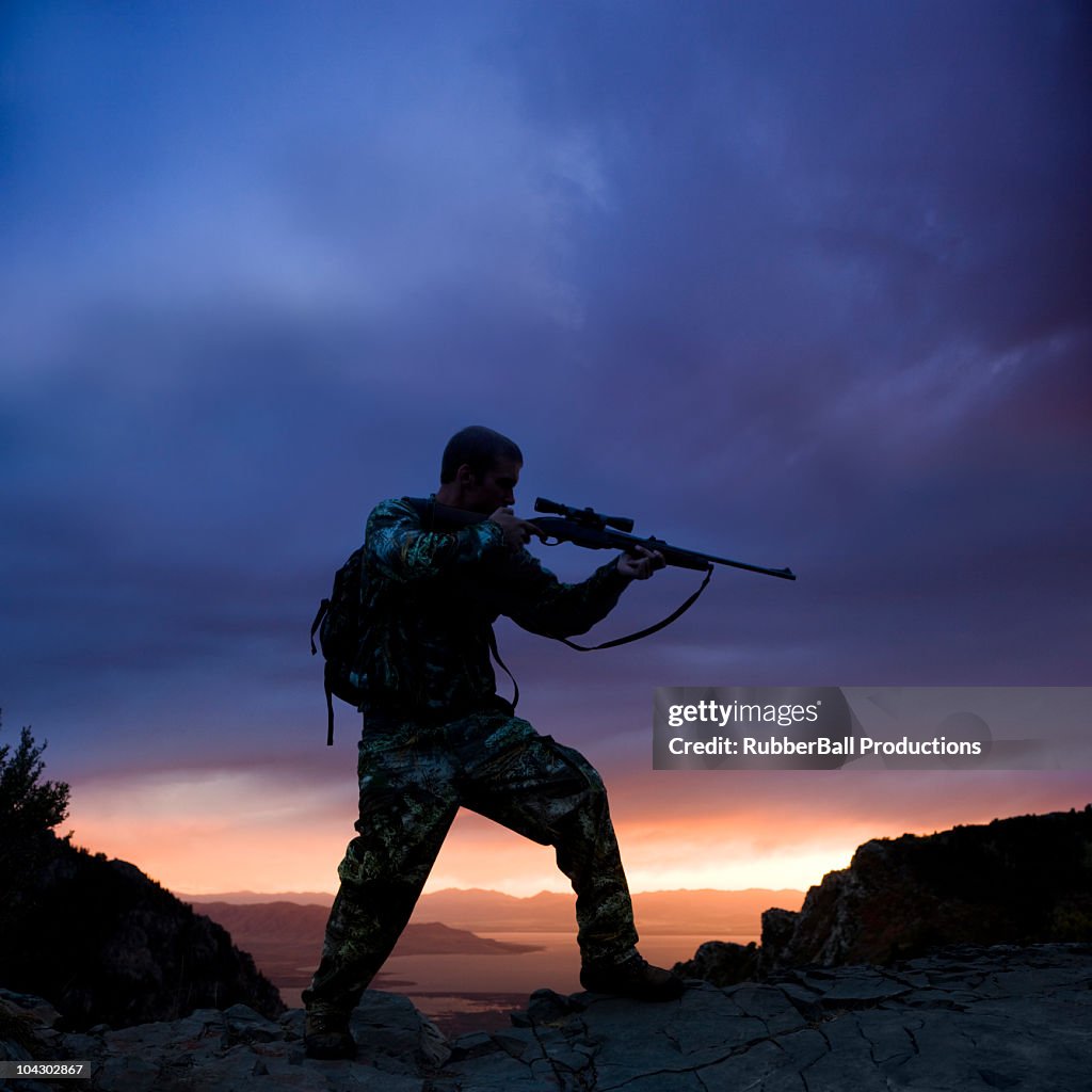 Hunter against a sunset