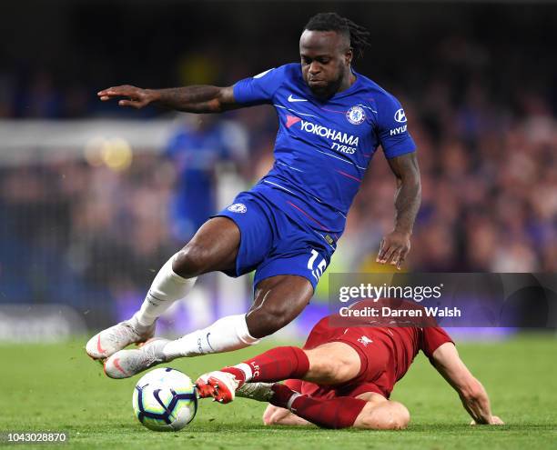 James Milner of Liverpool slides in to tackle Victor Moses of Chelsea during the Premier League match between Chelsea FC and Liverpool FC at Stamford...