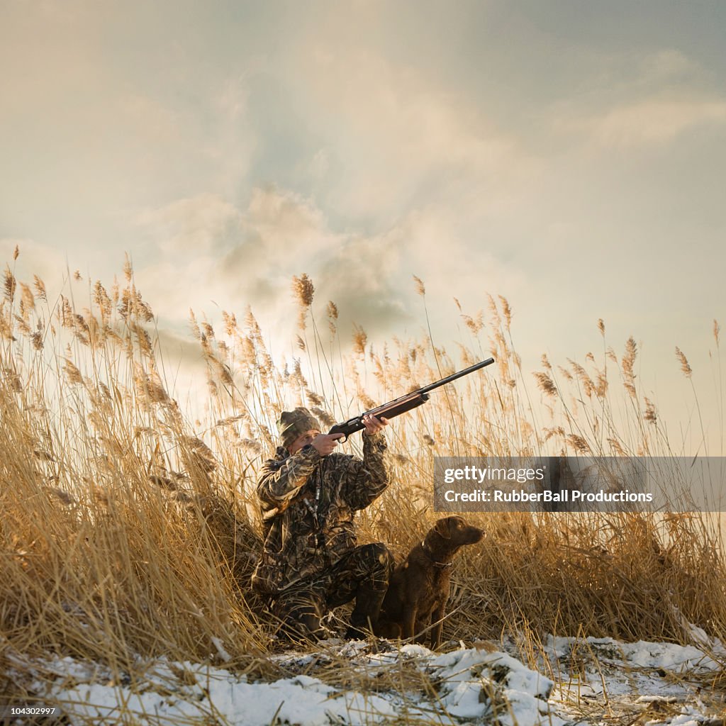 Man and his dog duck hunting