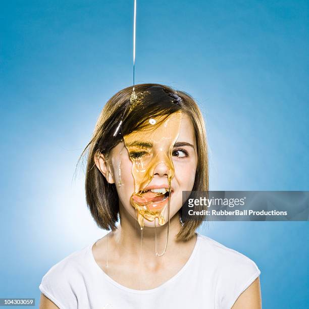 girl with honey pouring on her head - girls licking girls stock pictures, royalty-free photos & images