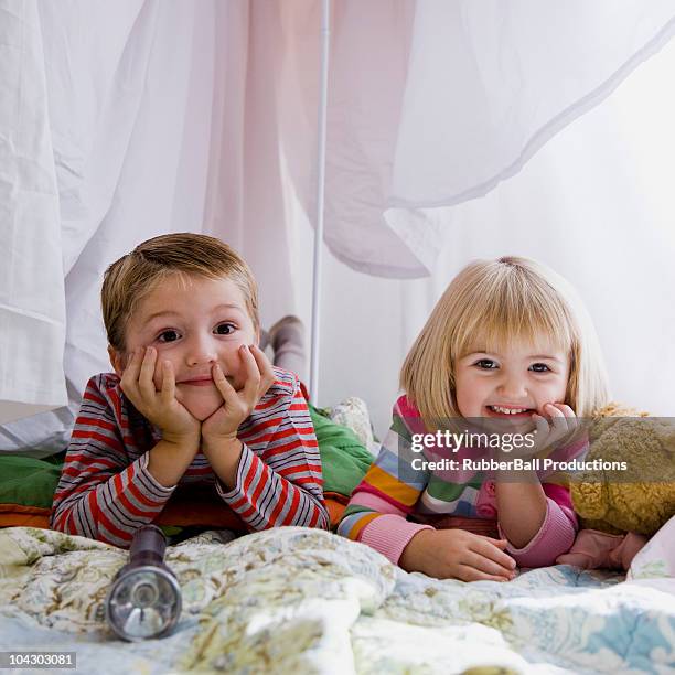 brother and sister in a makeshift fort - boys sleepover stock pictures, royalty-free photos & images