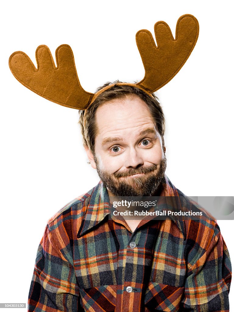 Man in a plaid shirt wearing antlers