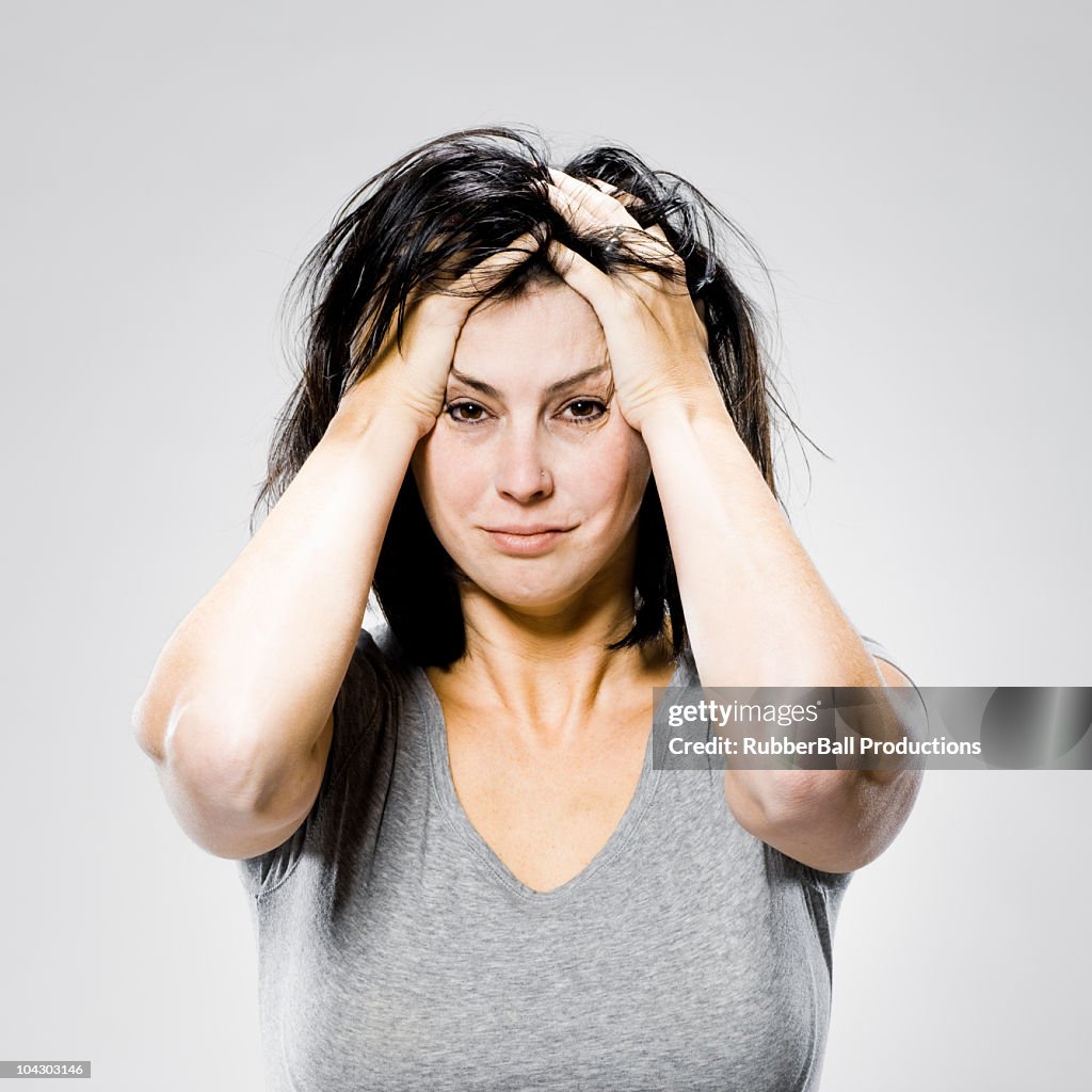 Woman with her hands on her head