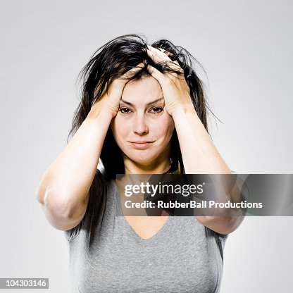 Woman with her hands on her head Woman with her hands on her head