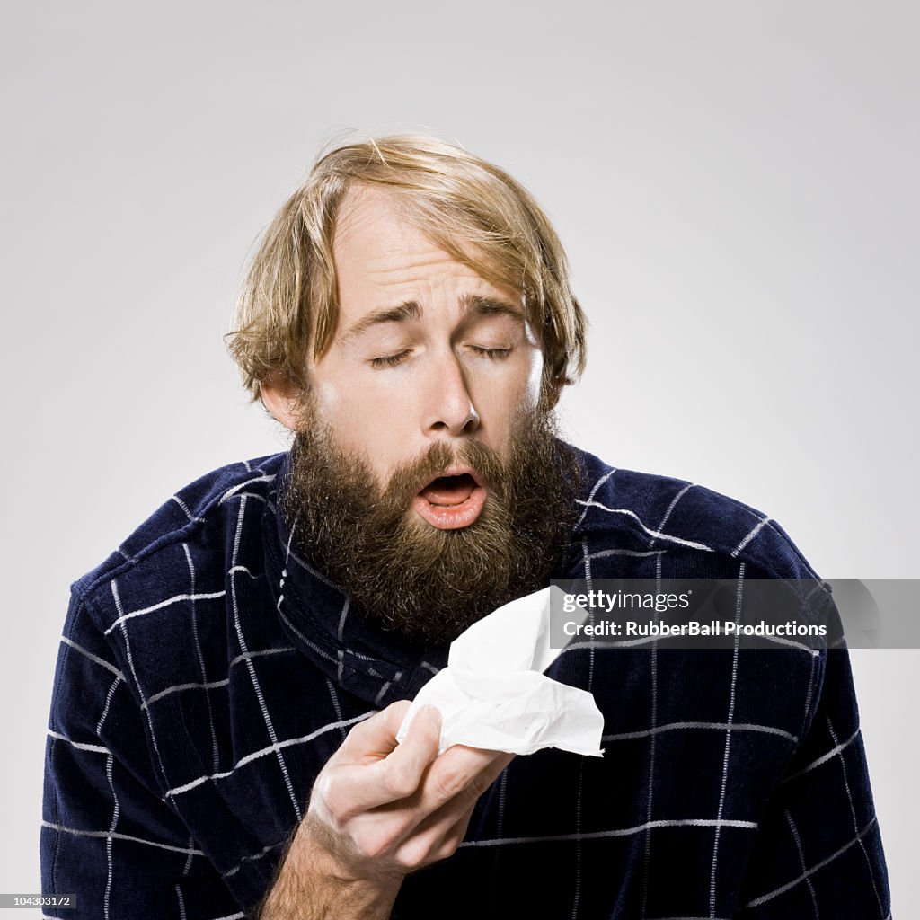 Bearded man with a cold wearing a robe