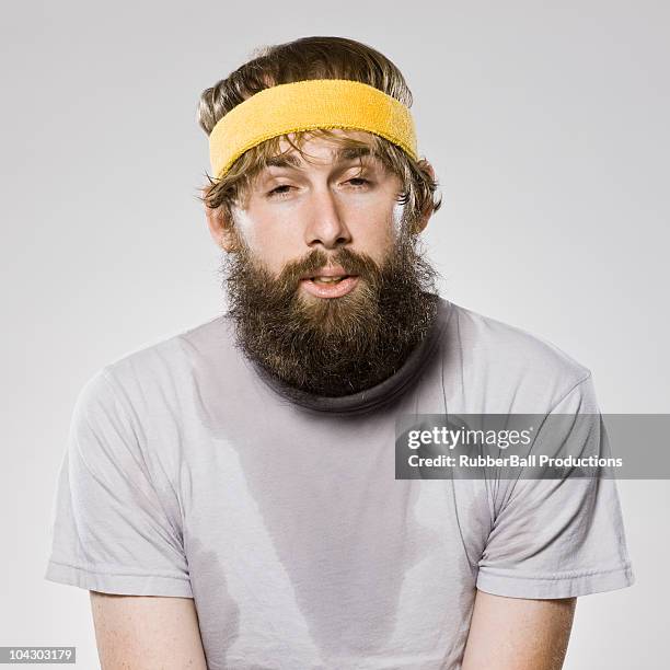 bearded man wearing a headband - kosmetisches stirnband stock-fotos und bilder