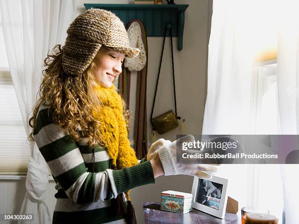 woman bundling up to go out into the cold - knitted house stock pictures, royalty-free photos & images