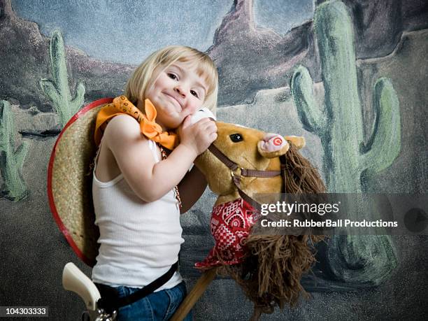 little girl dressed up as a cowgirl - hobby horse stock pictures, royalty-free photos & images