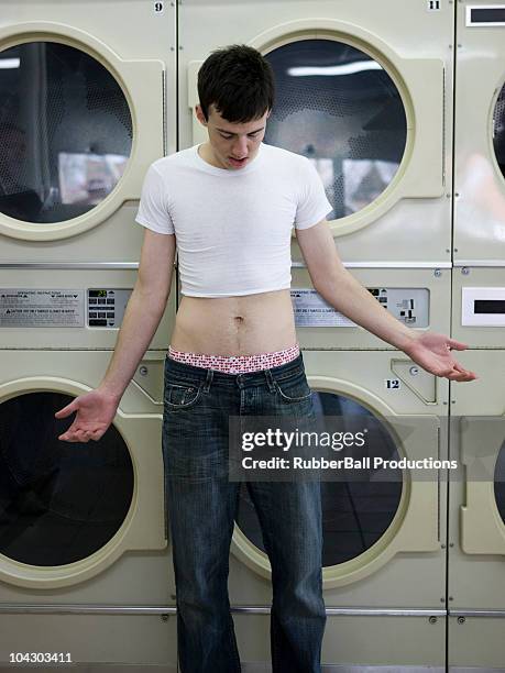 man wearing a shrunken t-shirt - clothing too small stock pictures, royalty-free photos & images