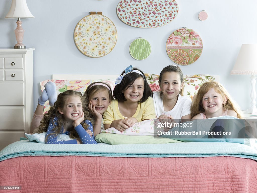 Five girls on a bed