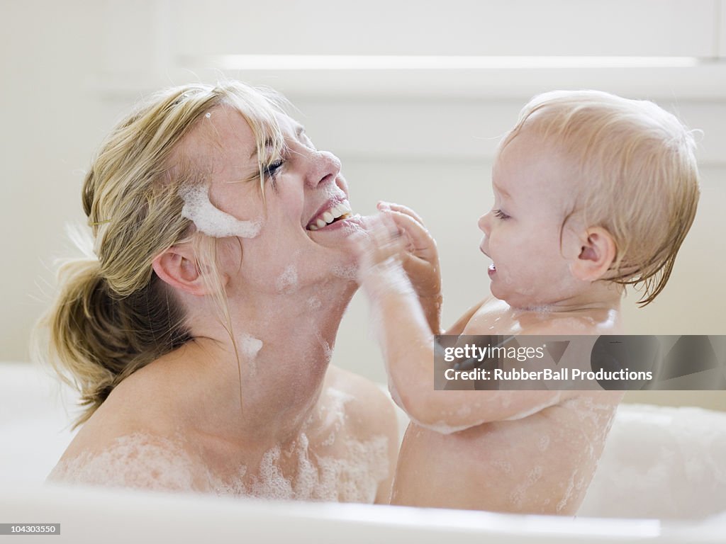 Mother and baby taking a bubble bath