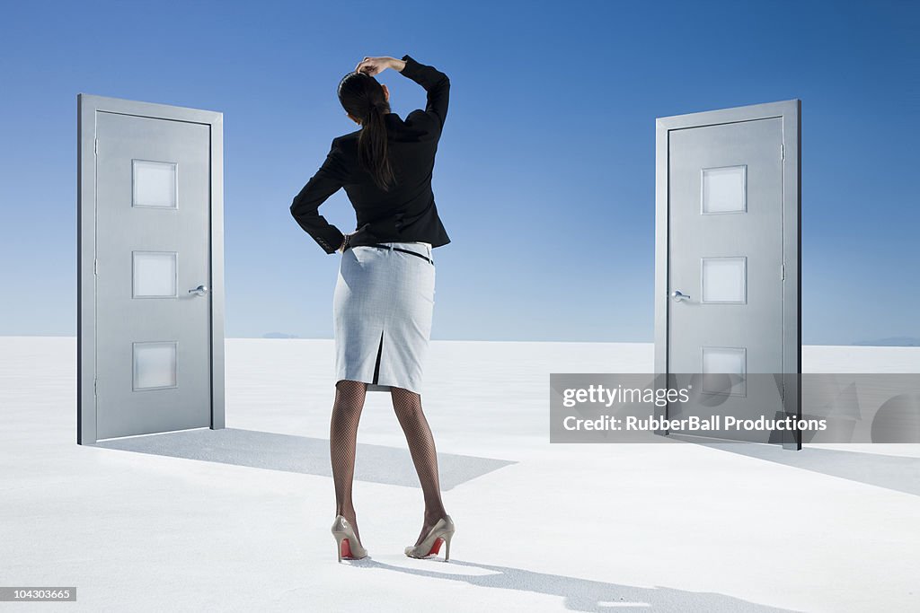 Business person choosing between two doors