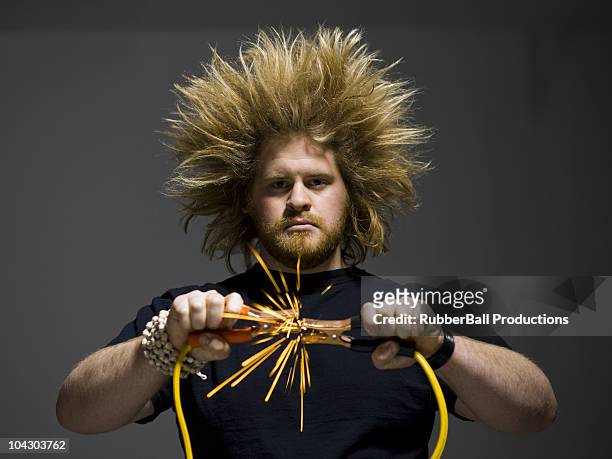 man holding jumper cables - jumper cables stock pictures, royalty-free photos & images