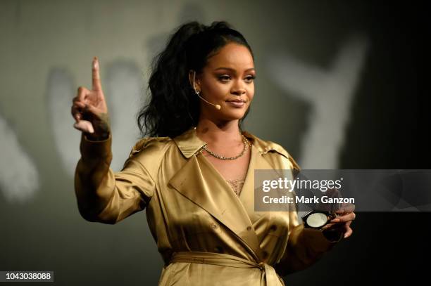 Rihanna gestures on stage during her Fenty Beauty talk in collaboration with Sephora, for the launch of her new Stunna Lip paint "Uninvited" on...