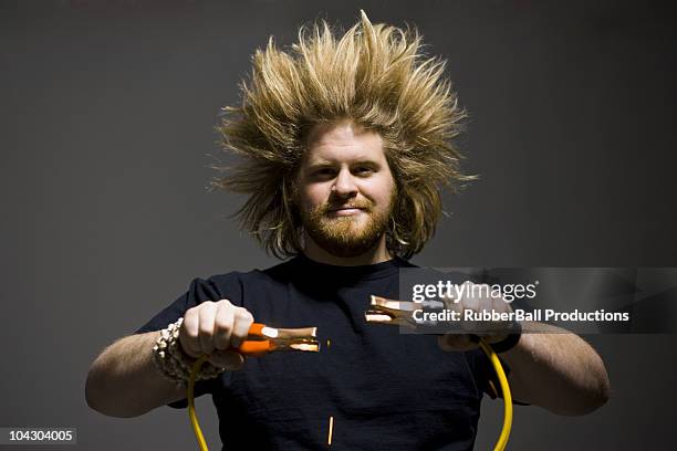 man with crazy hair holding jumper cables - hair standing on end stock pictures, royalty-free photos & images