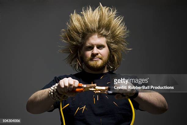 man with crazy hair holding jumper cables - hair standing on end stock pictures, royalty-free photos & images