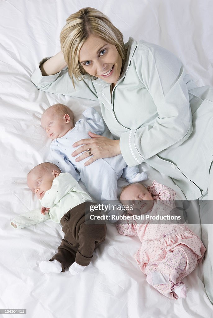 Mother with newborn triplets