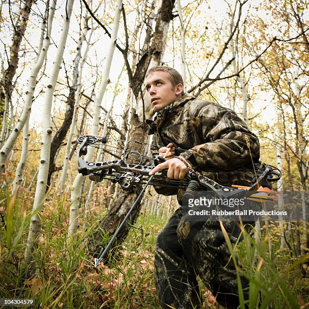 man hunting in the wilderness - hunting arrow foto e immagini stock