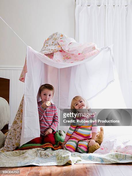 brother and sister in a makeshift fort - kids fort stock pictures, royalty-free photos & images