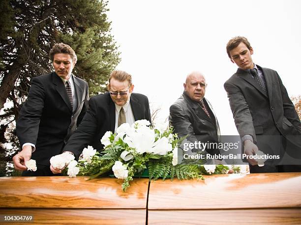 people at a funeral in a cemetery - mourning flowers stock pictures, royalty-free photos & images