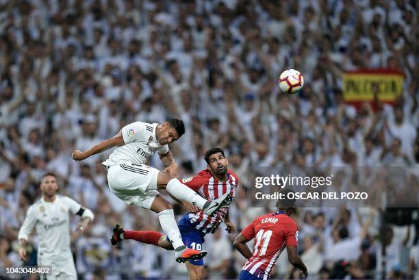 Real Madrid's Brazilian midfielder Casemiro and Atletico Madrid's Spanish forward Diego Costa jump for the ball during the Spanish league football...